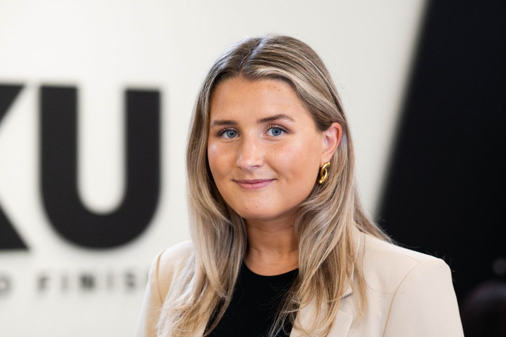 Woman smiling at the camera.